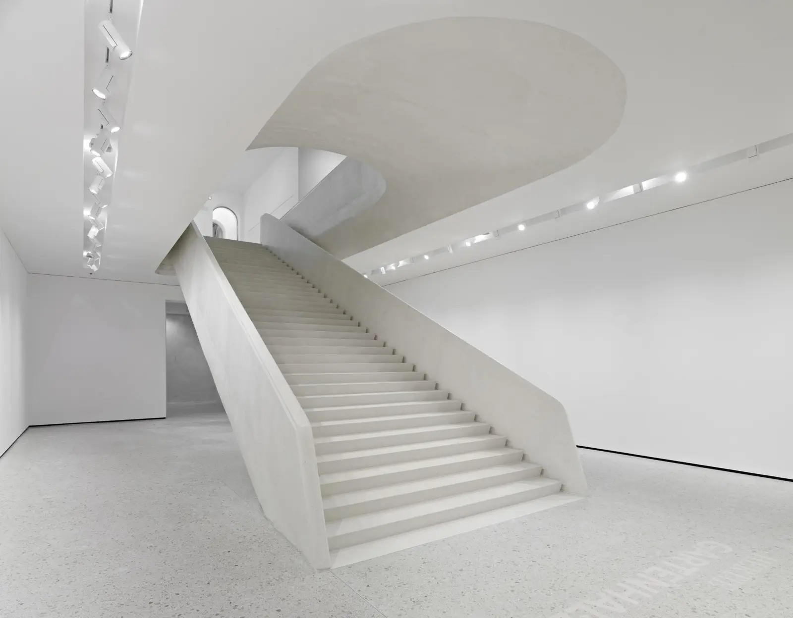 Staircase in Städel Museum with white interior and spotlights in the ceiling