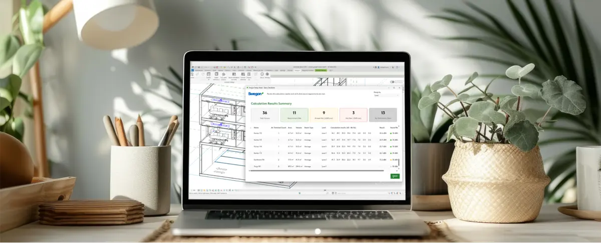 A laptop on a desk with plants, pens and other miscellaneous decor. The laptop screen is open and showing the plugin Design Assist.